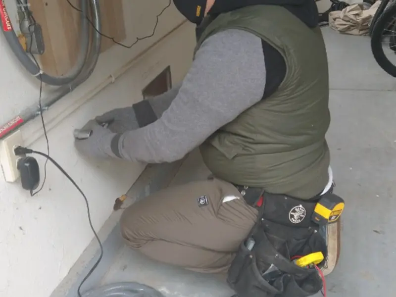 Electrician performing outlet wiring in a Fairhope garage