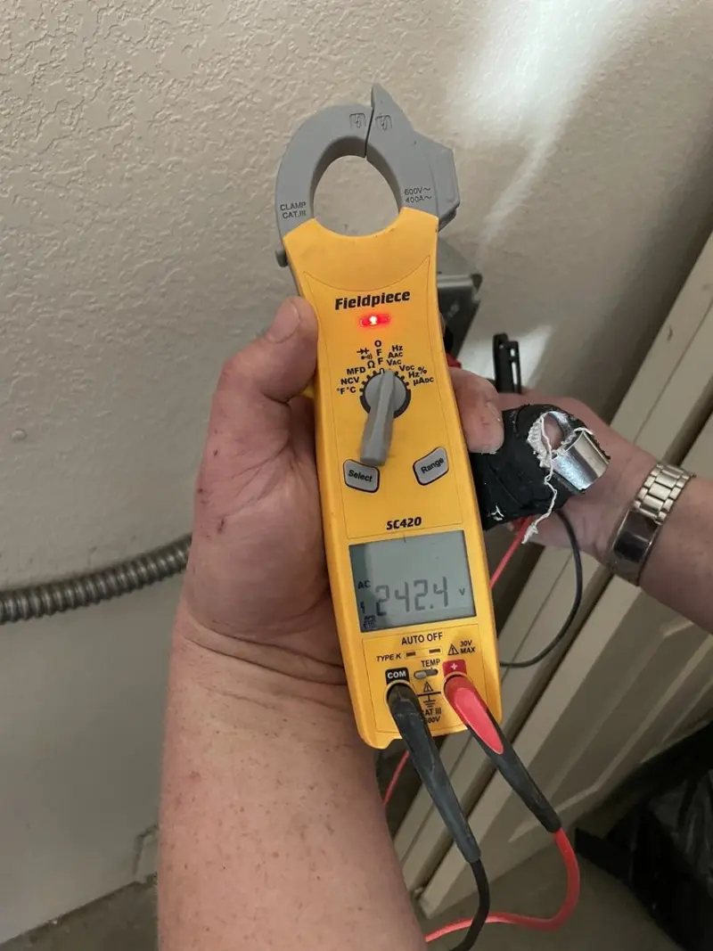 Voltage testing with clamp meter during Outlet Installation in Fairhope